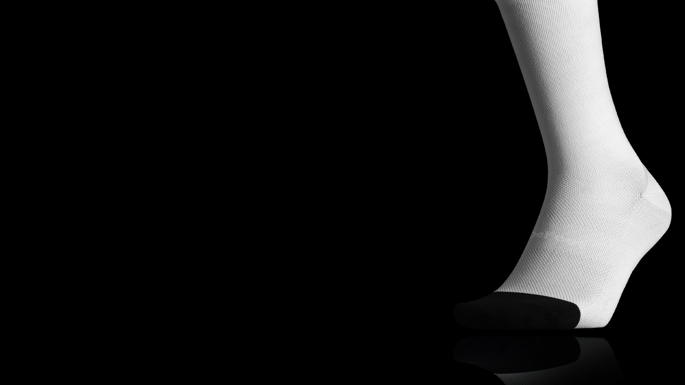 White DeFeet EVO Air sock against a black background