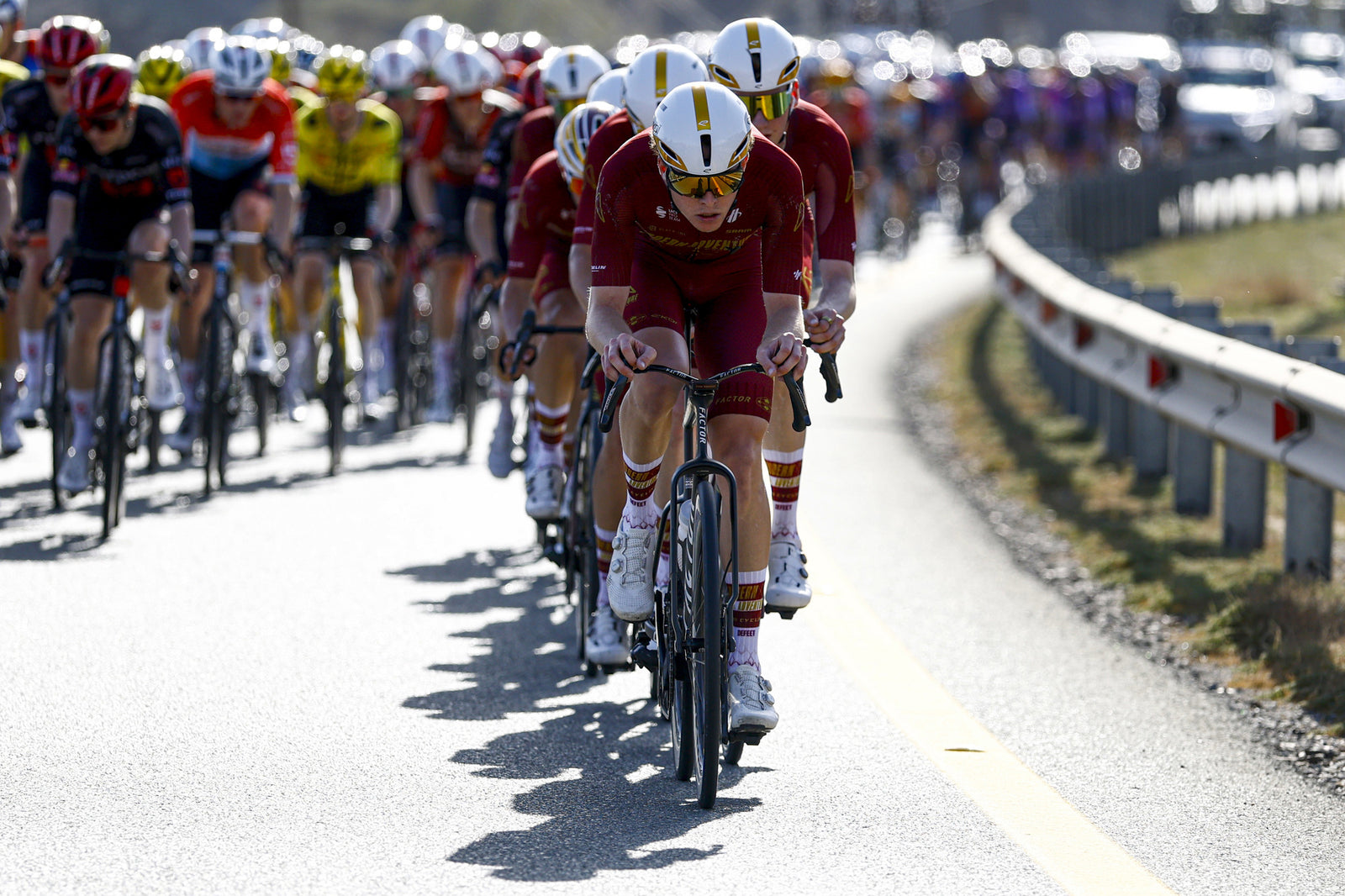 Modern Adventure road bike racers wearing custom DeFeet EVO Jet aerodynamic socks while riding at the front of a peloton
