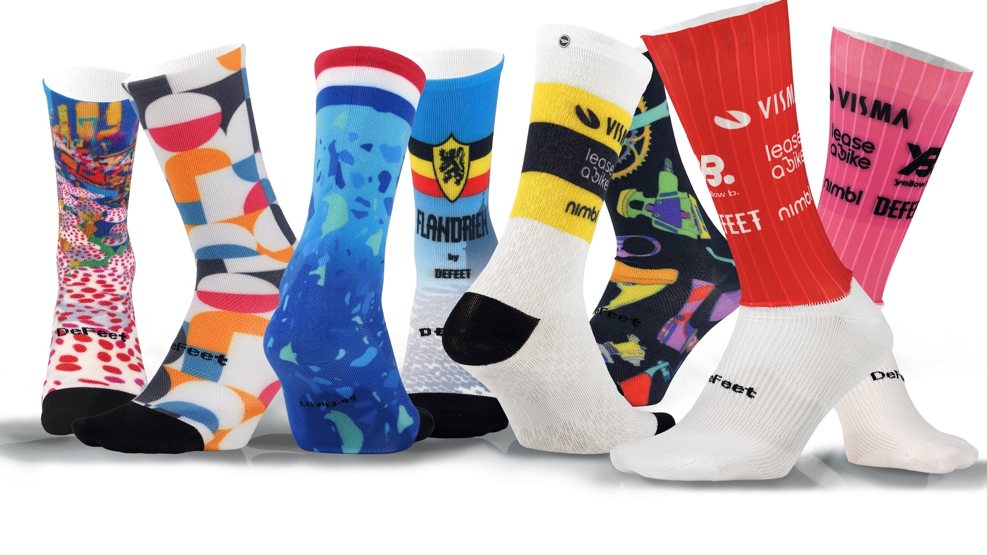 Collection of colorfully printed DeFeet socks with various designs and brands on a white background