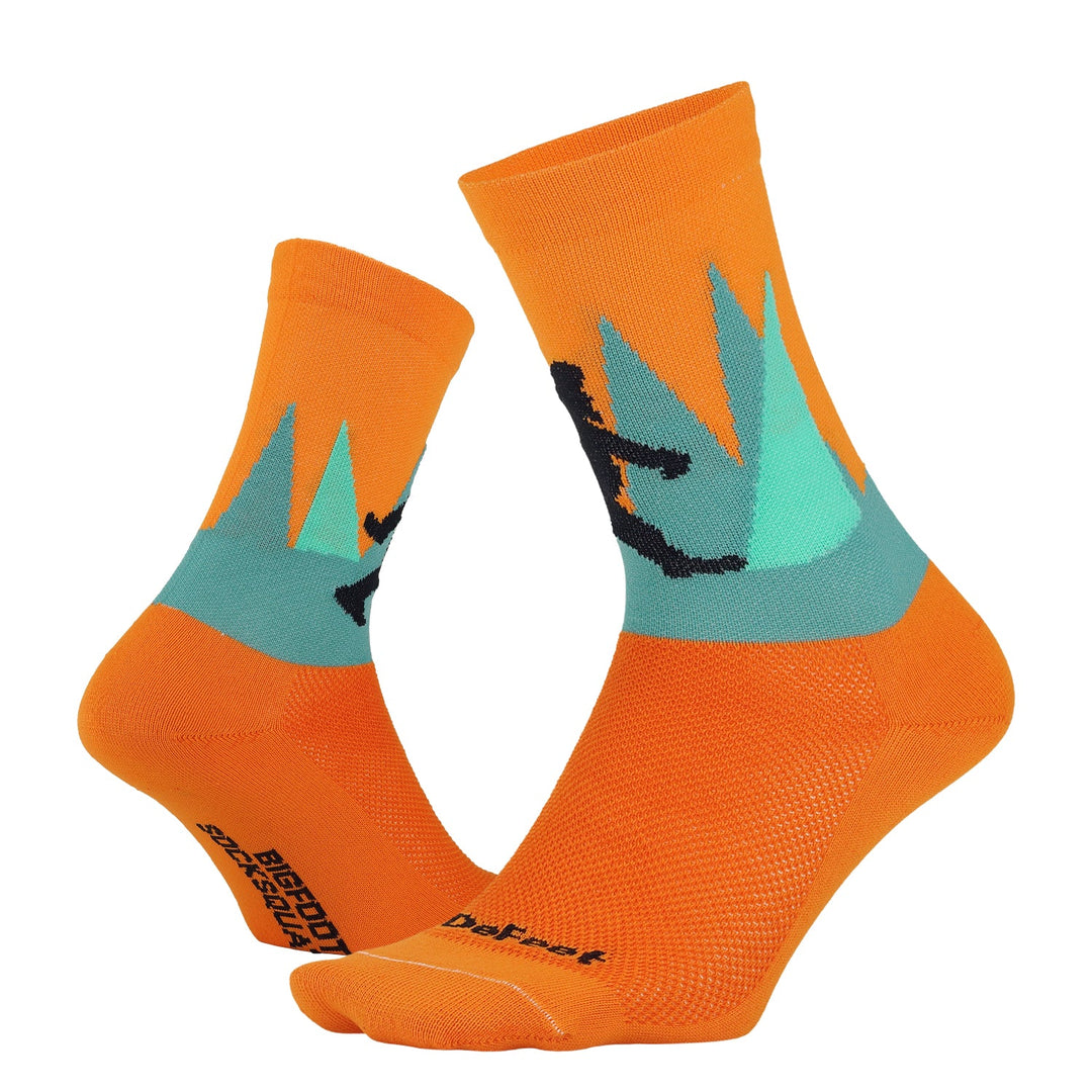 two orange crew athletic socks with bigfoot yeti sasquatch