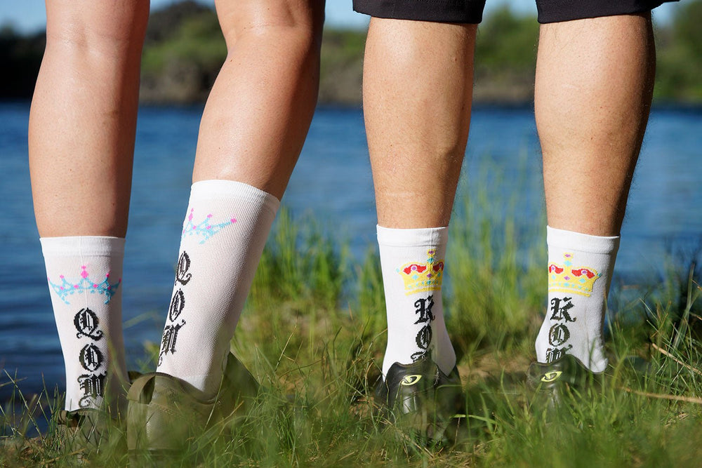 white cycling socks that say QOM or KOM on the back